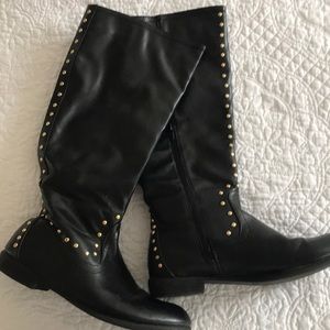 Black motorcycle boots with gold accents